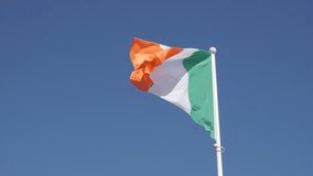 Irish flag waving in slow motion against blue sky1920X1080 HD footage - Famous tricolor state symbol fabric of Ireland on flagpole slow-mo 1080p FullHD video