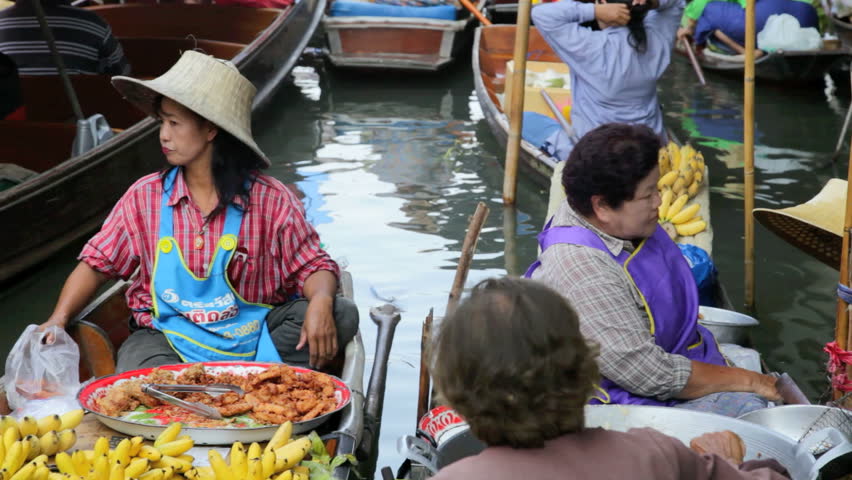 DAMNOEN SADUAK, THAILAND - FEBRUARY 25: Two Thai women are selling food on a