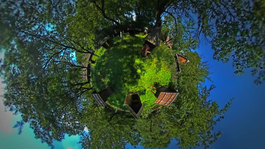 Tiny Little Planet 360 Degree Timelapse. Tourist, Man Among Beehives in Sunny Day, Rural Landscape. Hives on a Lawn. Man Walks Behind the Hut. Cottages in a Village. Blue Sky. Fresh Green Trees,