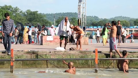 Old man taking dip in Holy Ganges. Haridwar, India. Shot on 28 August 2016.
(Pan from water to men)