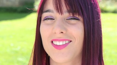 portrait of a pretty young woman with red hair, outdoor, slow motion
