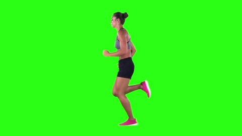 Woman running in sport clothing. Side view. Green screen. Slow motion