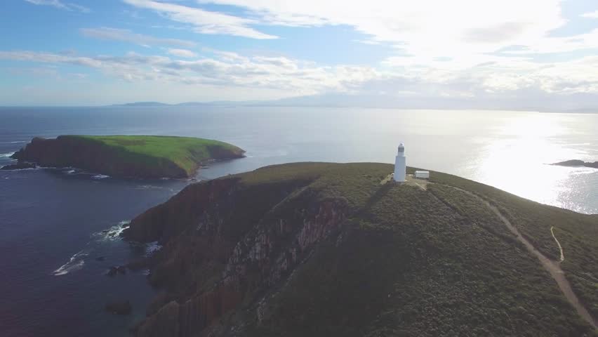 Orbit flight around Bruny Island Lighthouse revealing magnificent coastline, Tasmania, Australia