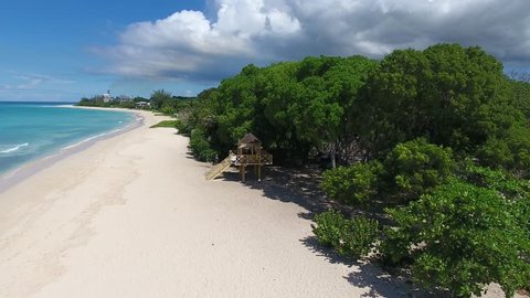 Aerial video of beautiful white sand beaches with lush green trees on a beautiful tropical Beach in the Caribbean 