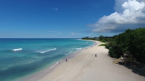 Aerial video of beautiful white sand beaches with lush green trees on a beautiful tropical Beach in the Caribbean 