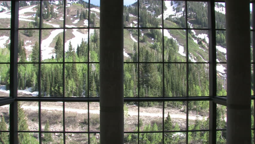 Resort lobby. Restaurant tables and expansive glass windows open to the mountains. Tilt down to restaurant.  Wasatch Mountains outside Salt Lake City, Utah. Luxury hotel, timeshare and resort.