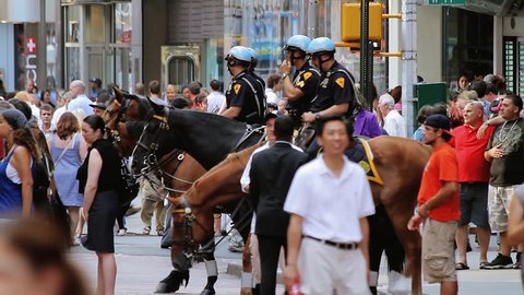 NEW YORK CITY - JUKY 29: NYPD officers on horseback and crowded Time Square on July 29th, 2010 in New York City. Times Square has become an iconic symbol of New York City and the United States.