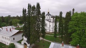 The Skete of All Saints. Valaam Island, Karelia from above. Monastery dramatic aerial drone video. Unique Russian historical and religion tourism place. Lake Ladoga. Pine forest. 4K footage.