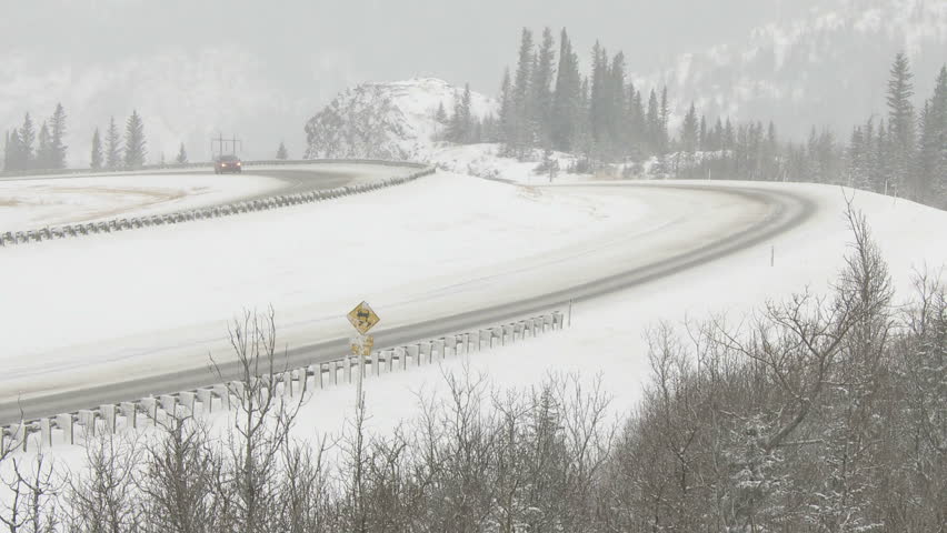 Cars traveling on snowy winter highway