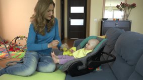 Nanny babysitter woman give food to cute infant at home. Zoom in shot. 4K UHD video clip.