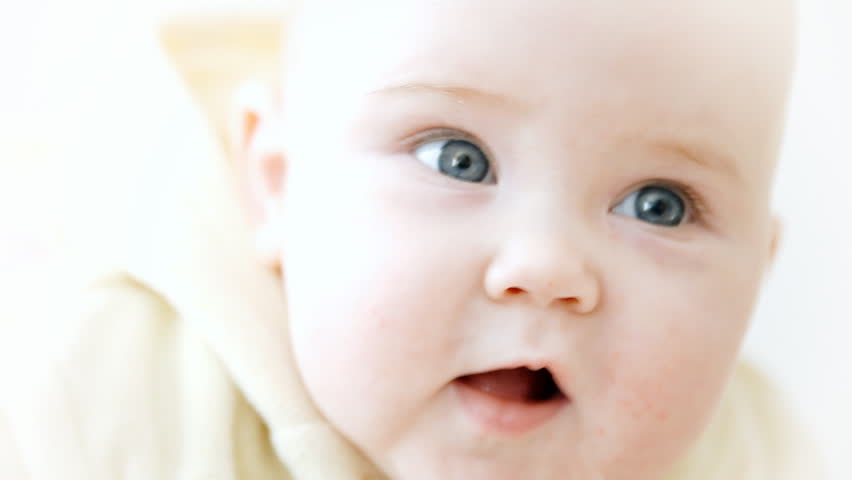 Smiling baby on the white background
