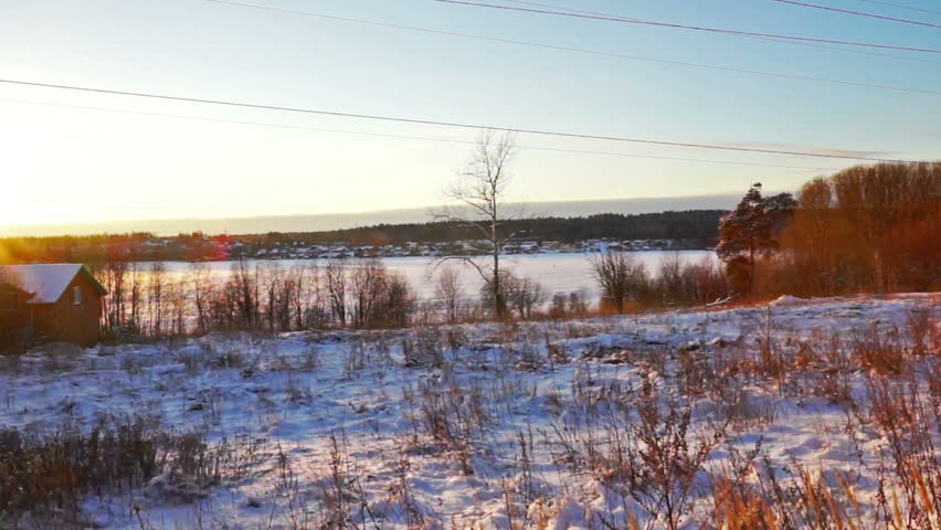 Wooden House on a Snowy Lake Shore in Winter Sunset, Full hd Shot in Counter Lighting