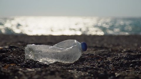 Environmental pollution:Plastic bottles at a coast. Video footage clip in UHD, 4K.