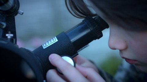 4k Technology and Astrology Child with Binoculars and Telescope, close-up