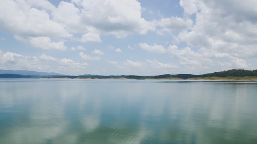 Rivers time lapse with white clouds on sky