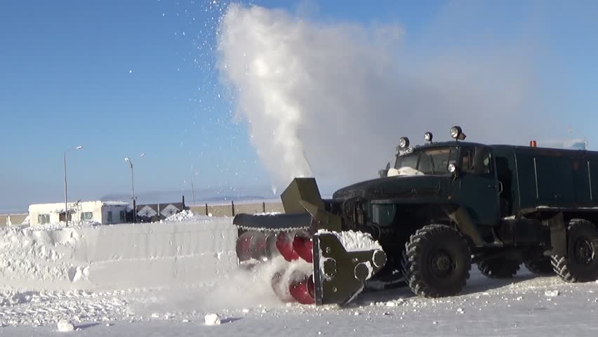 A snowplow clears the airfield
