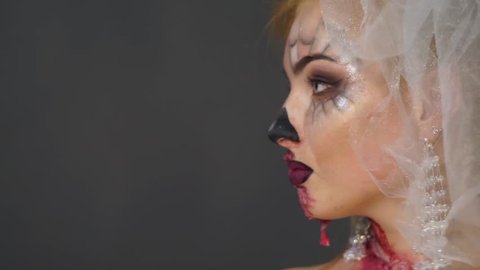 Dead bride stands in profile at first, then the front, gaze disfigured face (Halloween Make Up)