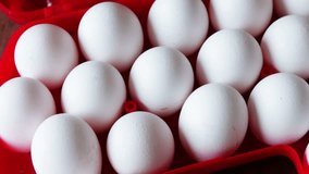 raw eggs in a red plastic tray or box