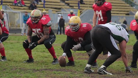 KYIV, UKRAINE - OCTOBER 18, 2015: Teams playing American football. Violent attack in match between amateur american football teams, active leisure