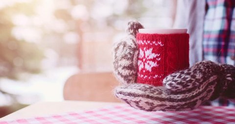 Woman Drinks Hot Tea or Coffee From Cup at Cozy Snowy House Garden on Winter Morning. 4K DCi SLOW MOTION 120 fps. Beautiful Girl Enjoying Winter Outdoors with a Mug of Warm Drink. Christmas Holidays