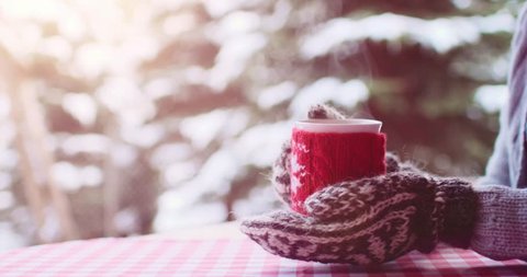 Woman Drinks Hot Tea or Coffee From Cup at Cozy Snowy House Garden on Winter Morning. 4K DCi SLOW MOTION 120 fps. Beautiful Girl Enjoying Winter Outdoors with a Mug of Warm Drink. Christmas Holidays