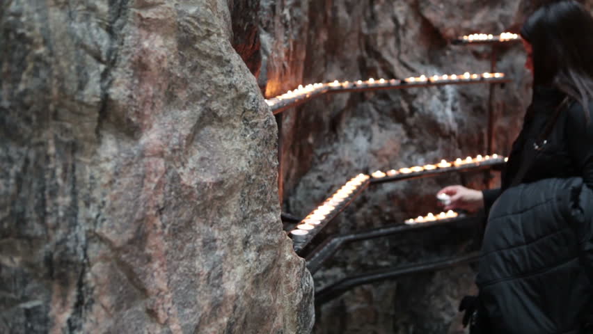 Prayers place candles on the wall of Finnish Church of the Rock. The Temppeliaukio church is in Helsinki city, Finland