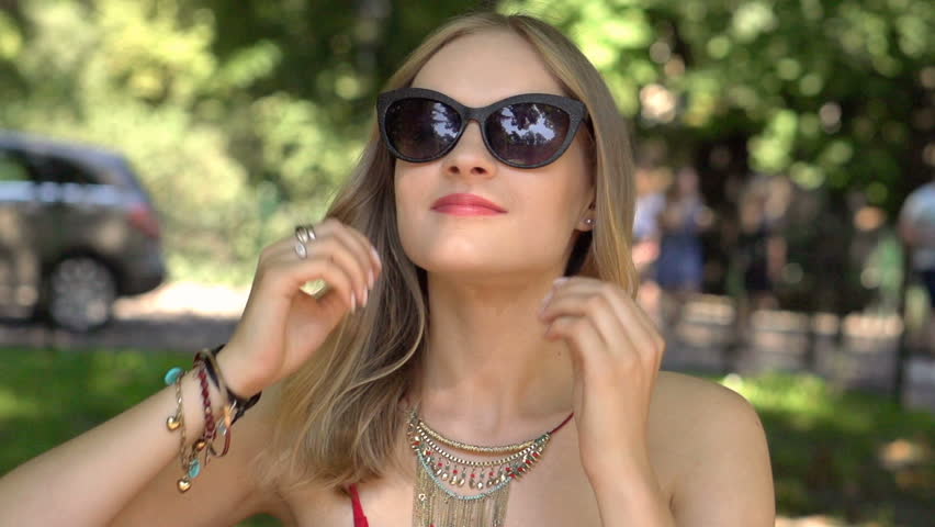 Pretty girl looking stylish while sitting in the park, slow motion shot at 240fps
