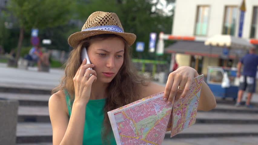 Confused girl lookin on map while talking, steadycam shot, slow motion shot at 240fps
