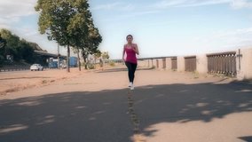 POV young woman running toward camera in urban city slow motion HD video. Female jogging: workout fitness outdoor training. Healthy lifestyle sport concept
