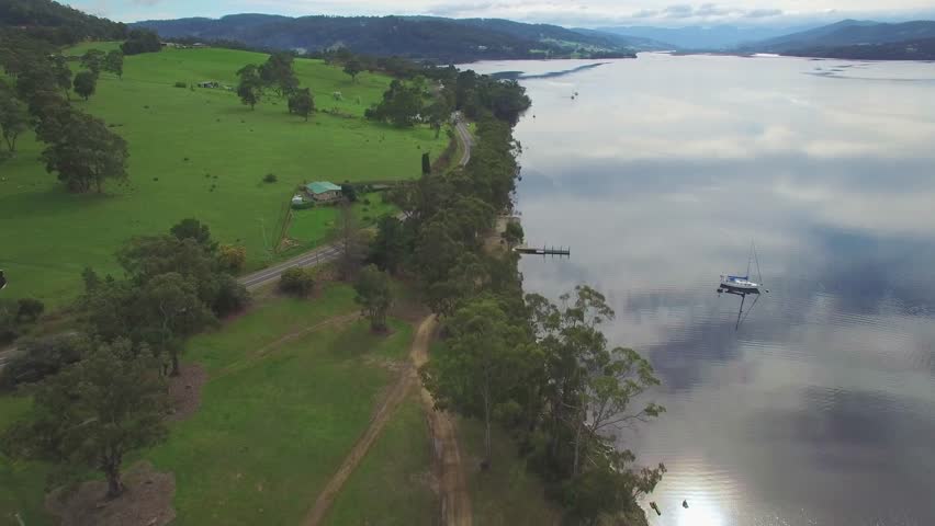 Forward flight above Huon River and Highway, Huon Valley, Tasmania, Australia