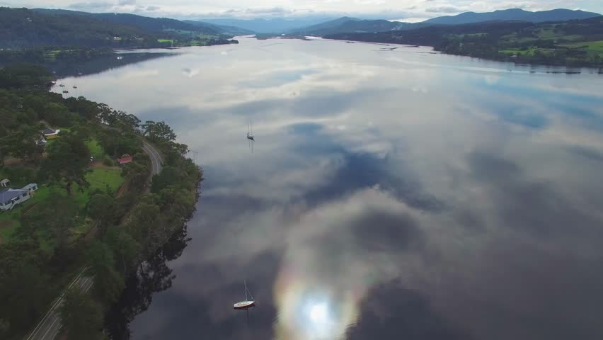 Forward flight over Huon River and moored boats. Huon Valley, Tasmania, Australia