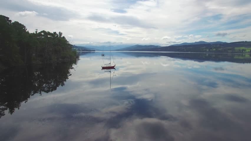 Slow rise above Huon River and moored sailboats.  Huon Valley, Tasmania, Australia