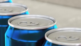 Soft drink or beer production line. Blue aluminum cans on industrial conveyor, shallow focus. Recycling ecologic packaging. 4K seamless loopable clip
