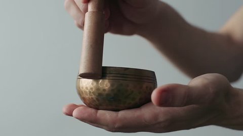 Small Tibetan Singing Bowl Being Made to Sing in Ones Hand.