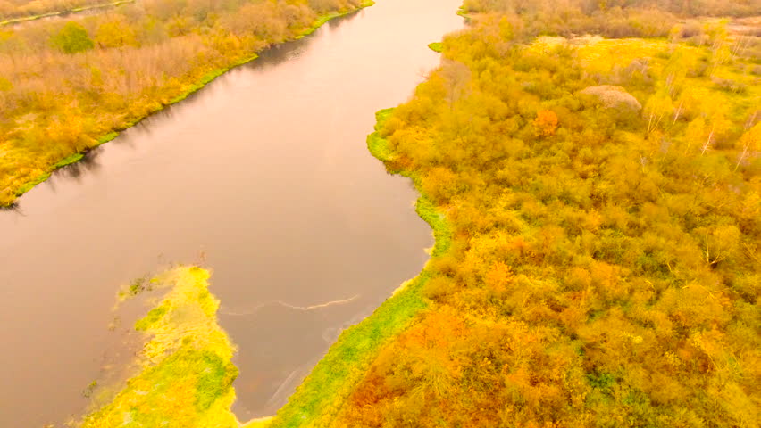 Aerial View. Golden Autumn flyingnear the fishermen on the boat over river near yellow tree. 4K 30fps ProRes (HQ)