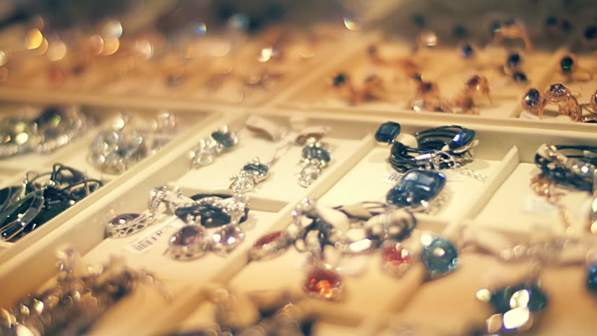 Beautiful jewelry on store shelves shimmer in different colors in rays of light. Closeup. Shallow depth of field Royalty-Free Stock Footage #20673556
