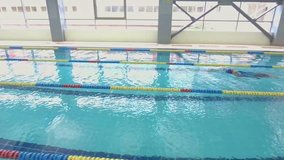 Professional woman swimmer training in swimming pool