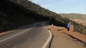 Atlas mountains in Morocco panoramic video with unrecognized man standing on the road afar
