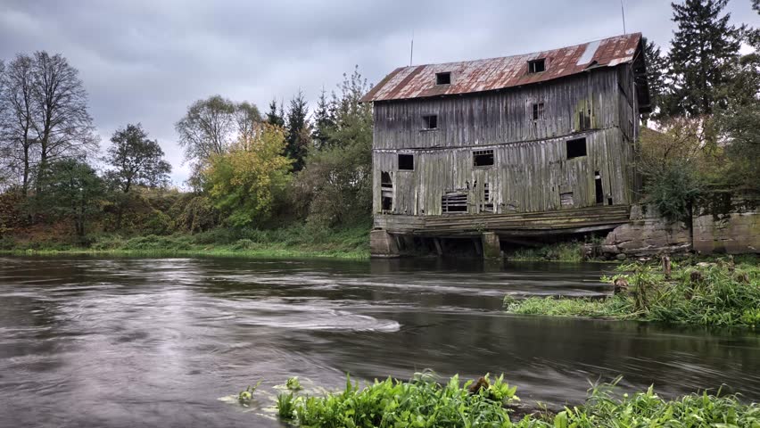 Old haunted house at river bank.