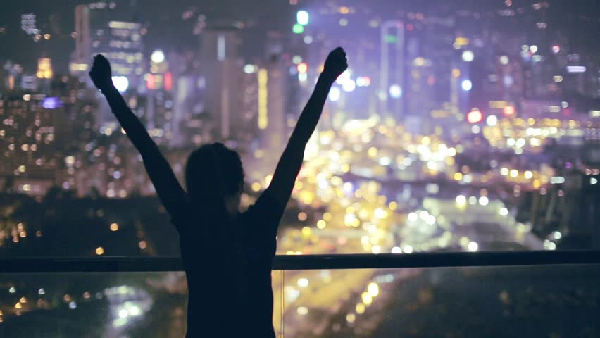 Silhouette of a young happy girl feeling awesome on the rooftop with great view over city. Success and happiness concept. Hong Kong, China.  Royalty-Free Stock Footage #20695510