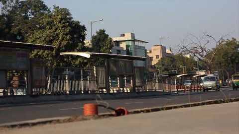 NEW DELHI, INDIA - JANUARY 18: Car traffic, autorickshaws and bicycle rickshaws drive in downtown Delhi on January 18, 2011. Slow motion shot. 