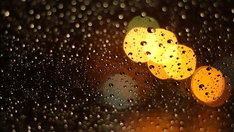 night traffic lights with water drop in rainy weather