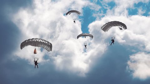 Military parachutists lands on a background of clouds and blue sky