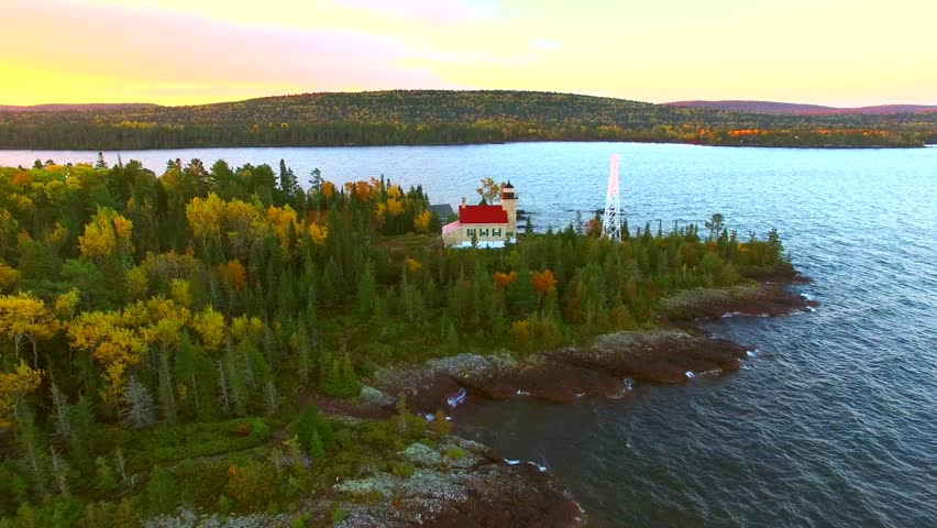 Scenic Copper Harbor Michigan lighthouse with Autumn colors, at dawn, aerial view.
