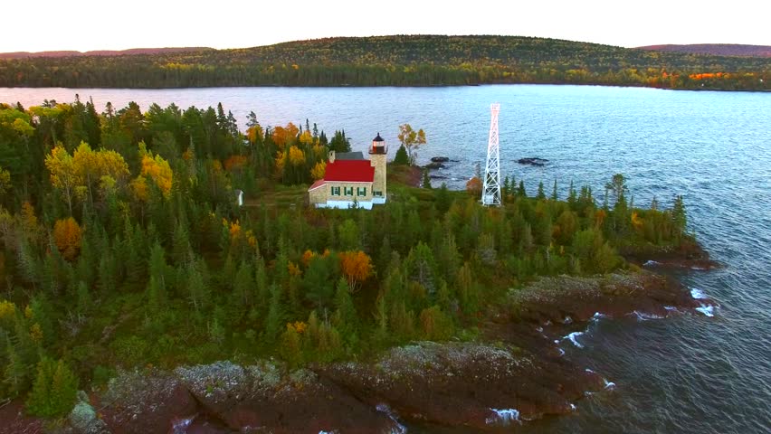 Scenic Copper Harbor Michigan lighthouse with Autumn colors, at dawn, aerial view.
