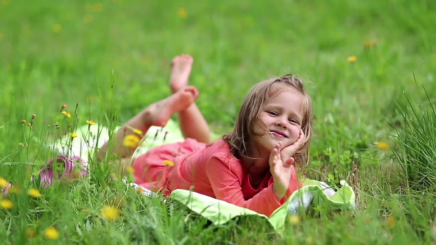 little girl lying on green grass Stock Footage Video (100% Royalty-free ...