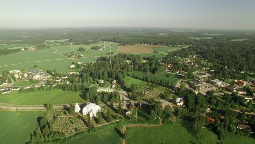 Aerial shot of the small countryside muncipality of Myrskyla in Finland with the local church and graveyard in the foreground.