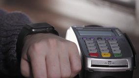 Customer paying with NFC technology by smart watch contactless on terminal in modern cafe - Powered by Shutterstock - Get 15% off with code: PIKWIZARD15