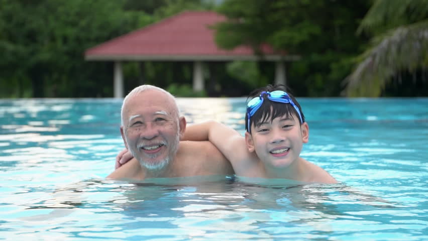 Slow motion of Happy asian family playing in pool, Asian grandchildren and grand parents swimming in pool. Royalty-Free Stock Footage #20732116
