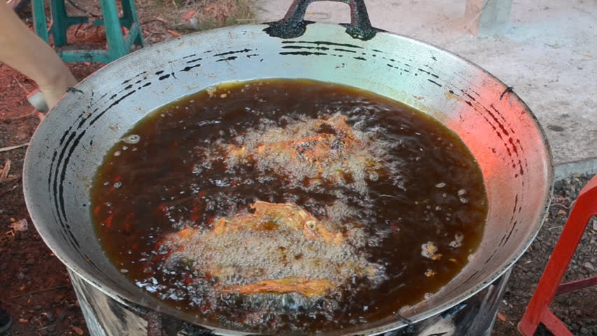 frying chicken in pan of thailand market
